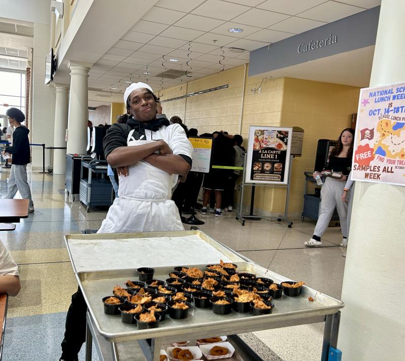 Culinary student Ja'Kai Ni-Siem Cropper passes out chicken tinga and onion rings.